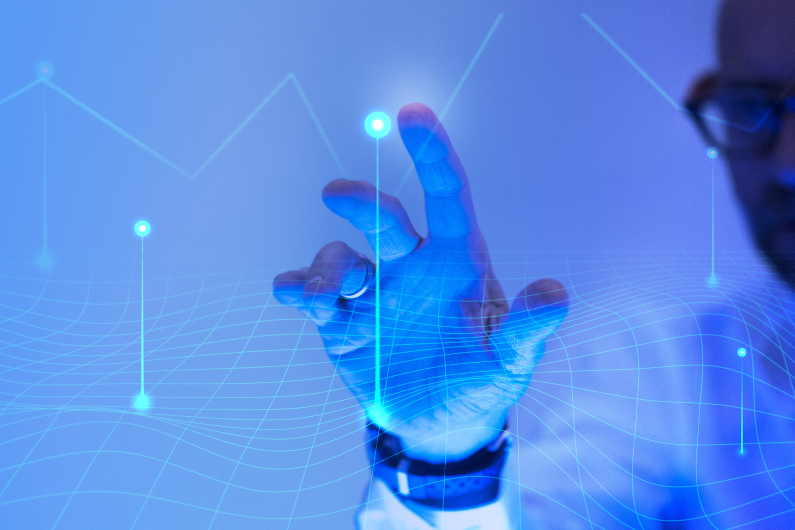 Man touching the futuristic blue screen